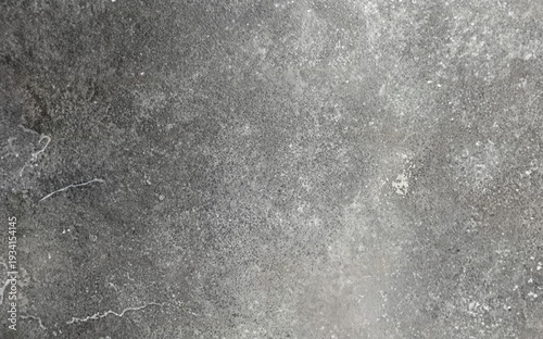 Detailed gray concrete wall texture featuring a rough industrial surface with natural stains, scratches, and subtle tonal variations for background use.