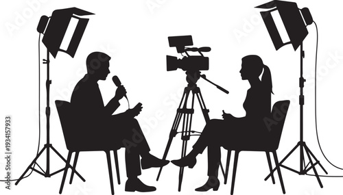 Silhouette of man and woman in interview setting with camera and