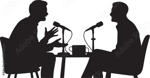 Two men sitting at a table with microphones and a mug
