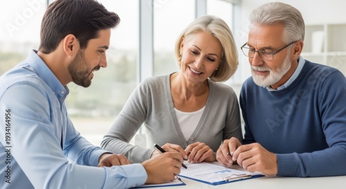 Advisor Helps Couple Sign Paperwork Smiling