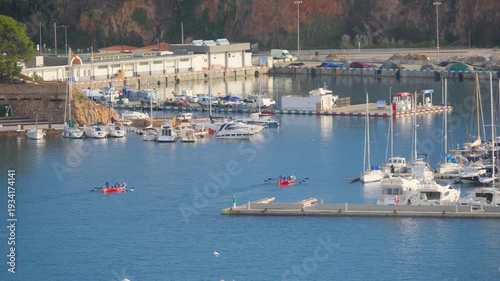 Rowing teams training in sant feliu de guixols harbor