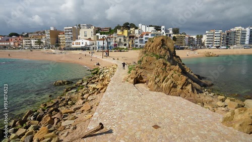 Panoramic view of blanes beach in costa brava with person walking