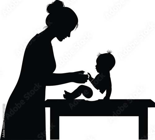 a silhouette depicting a mother carefully tending to her baby on a changing table showcasing parental care and bonding high quality