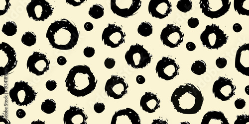 Abstract black brushstroke pattern on a cream colored background