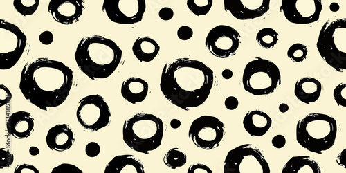 Abstract background featuring irregular black brushstroke circles on a cream canvas