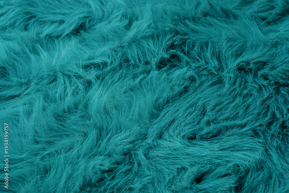 Obraz premium Luxurious vibrant deep teal color fuzzy texture background featuring soft fluffy fabric material surface