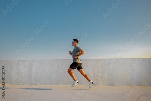 Runner practices on rooftop during sunset, enjoying outdoor workout for fitness and health