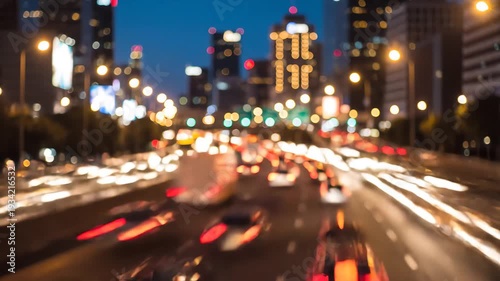 Blurry motion blur of a busy highway at night with streaks of car headlights and taillights creating a vibrant urban light show with city skyscrapers in the background.