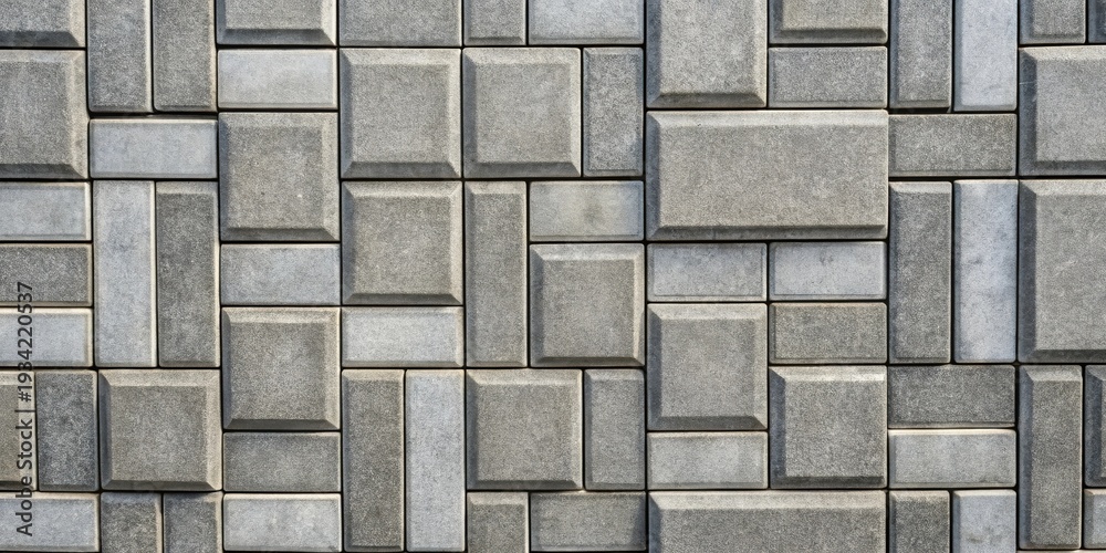 Obraz premium Interlocking Gray and Light Gray Stone Blocks Forming a Complex Geometric Pattern