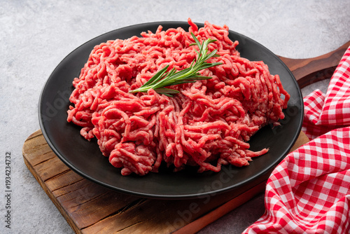 Raw ground meat on old grey  stone table background	