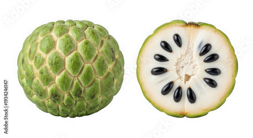 A green fruit with a white interior and black seeds