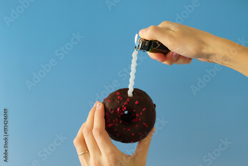 hand holding a strawberry donut