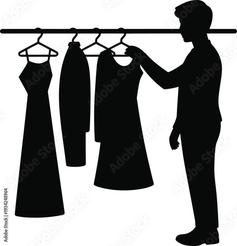 A person selecting a dress from a clothing rack with multiple dresses hanging