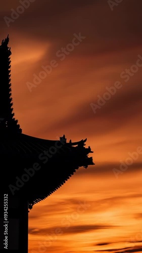 Silhouette of a traditional temple pagoda roof at sunset horizon