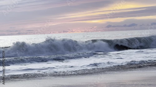 A colorful sunset reflects off the calm seas, Ocean.