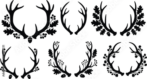 Minimalist vector art close up antler wreaths with oak leaves acorns eight decorative black silhouettes isolated on white top view flat design elegant ornamental badge elements