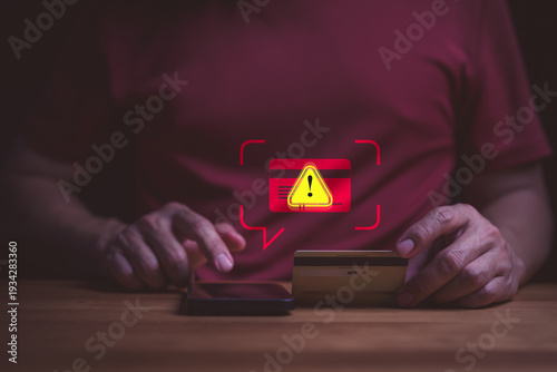 Credit card fraud alert and cyber security concept. User on smartphone with online payment scam warning. Phishing, identity theft, hacked banking account, and data protection risk.