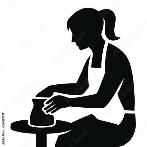 A silhouetted woman skillfully shapes clay on a pottery wheel creating a vessel high quality