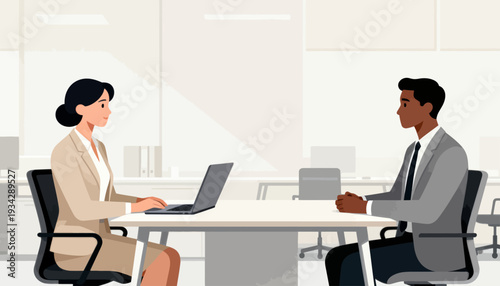 Two professionals sit across a table, engaged in conversation. Woman types on a laptop, focused and attentive. Man listens, posture suggesting interest and respect