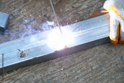 Workers are welding steel at a construction site; steel welding concept.
