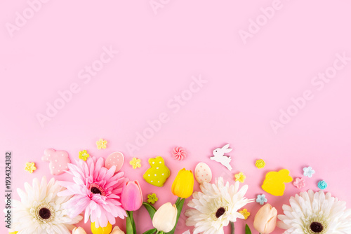 Beautiful spring flowers bouquet with Easter decorations on pink background