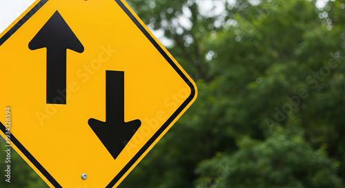 Traffic sign indicating two-way traffic with yellow background  