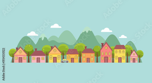 Colorful houses in a row with mountains in the background.
