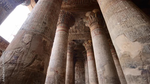 Egypt. Esna temple hypostyle hall with massive painted columns and colorful hieroglyphic reliefs on ceiling in Egypt, ancient Roman-era architecture with preserved pigments and carvings.