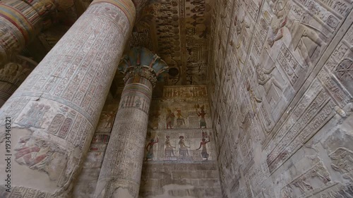 Egypt. Esna temple hypostyle hall with massive painted columns and colorful hieroglyphic reliefs on ceiling in Egypt, ancient Roman-era architecture with preserved pigments and carvings.
