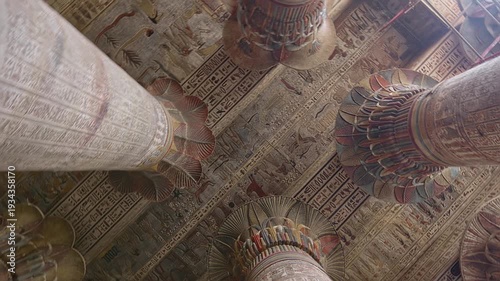 Egypt. Esna temple hypostyle hall with massive painted columns and colorful hieroglyphic reliefs on ceiling in Egypt, ancient Roman-era architecture with preserved pigments and carvings.