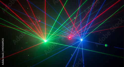 Colorful laser light show beams in dark nightclub atmosphere.