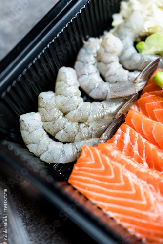 Wallpaper Mural Fresh salmon and raw peeled shrimp neatly arranged in box served with fresh vegetable and bitter melon. Torontodigital.ca