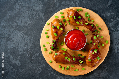 Wallpaper Mural Fried chicken legs with sauce on a black table, top view. Roast chicken drumsticks on a black table. Torontodigital.ca