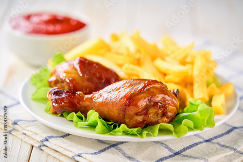 Wallpaper Mural Grilled chicken drumsticks with ketchup and french fry on a white wooden table. Torontodigital.ca