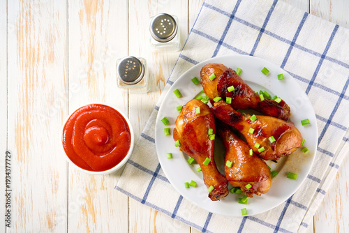 Wallpaper Mural Grilled chicken drumsticks with sauce on a white table, top view. Torontodigital.ca