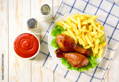 Wallpaper Mural Fried crispy chicken legs with ketchup and french fry on a white table, top view. Torontodigital.ca