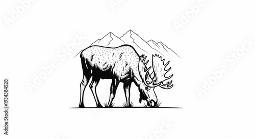 A majestic moose with large antlers grazes in front of mountain peaks