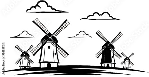 Silhouette of windmills against a cloudy sky