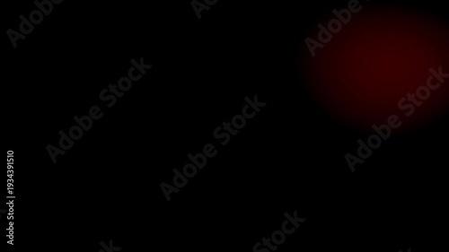 light leaks transition. Subtle, diffused dark red light source against a deep black, minimalist background.