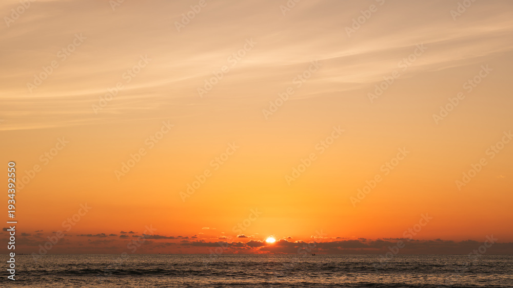 Obraz premium Sunset sky Clouds over sea in the Evening with Orange, Yellow sunlight on golden hour, Horizon sea sky landscape nature background, Summer sea Sky
