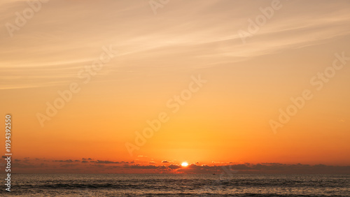 Sunset sky Clouds over sea in the Evening with Orange, Yellow sunlight on golden hour, Horizon sea sky landscape nature background, Summer sea Sky