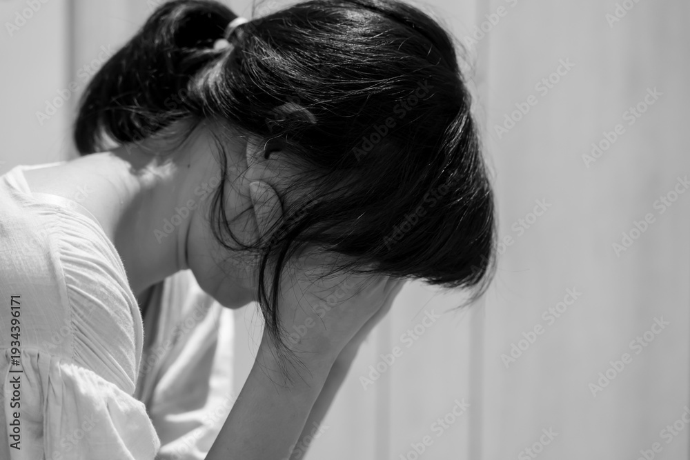 Fototapeta premium Monochrome picture, Depression and mental illness. Asian woman disappointed, sad after receiving bad news. Stressed girl confused with unhappy problems, cry and worry about unexpected pregnancy.