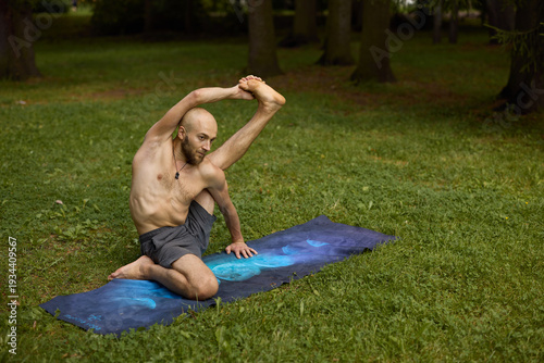 Quadro em tela Man barefoot on mat practicing spinal elongation and breath control