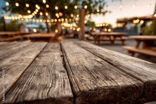 Rustic Wooden Table at Outdoor Evening Gathering with String Lights.