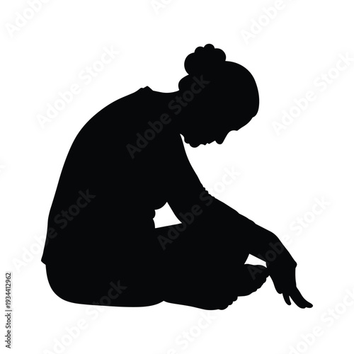 Serene woman sitting in contemplative silence with hair in bun