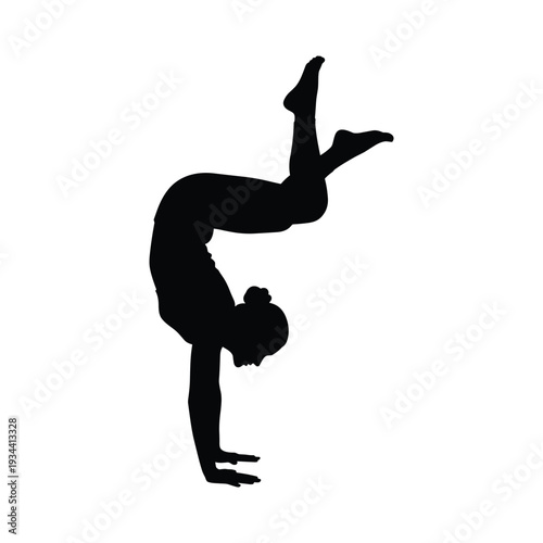Silhouette of woman performing handstand with one leg raised high