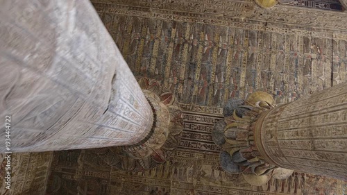 Egypt. Esna temple hypostyle hall with massive painted columns and colorful hieroglyphic reliefs on ceiling in Egypt, ancient Roman-era architecture with preserved pigments and carvings.