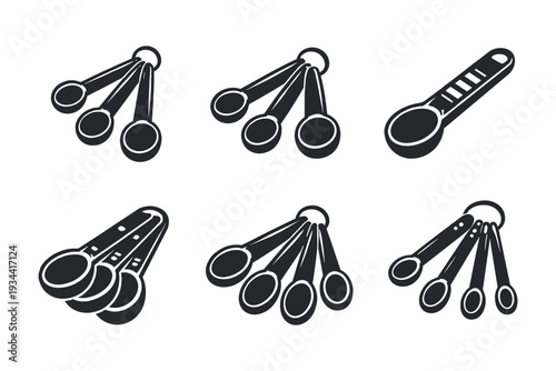 Collection of measuring spoons in various styles and sizes, isolated on white background