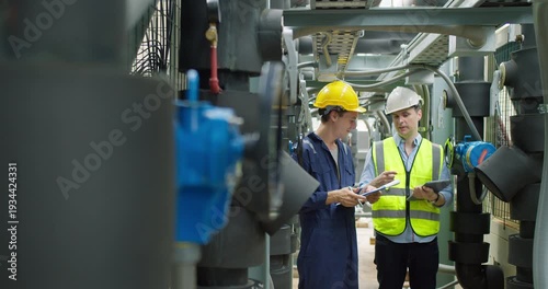 Professional engineers are inspecting mechanical valves and pipeline systems in a modern industrial factory, focusing on facility safety compliance and operational efficiency.
