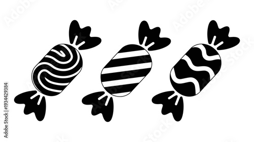 A trio of stylized black candy icons exhibits varied wrapper designs.